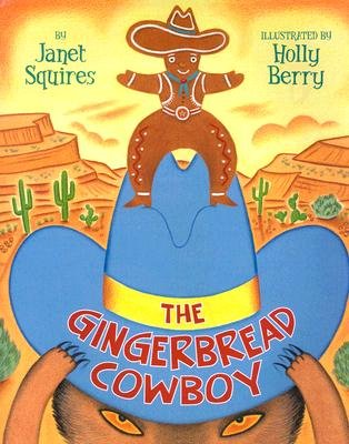 The Gingerbread Cowboy by Janet Squires book cover features a bold, oversized blue cowboy hat takes centre stage, its wide brim framing the scene and drawing the eye immediately. Perched on top of the hat is the gingerbread cowboy figure — complete with hat, boots, vest and big belt buckle — striking a confident pose against a warm, sun‑shaded desert backdrop of mesas, cacti and golden sky. The title, “THE GINGERBREAD COWBOY,” is written in playful red uppercase letters on the hat’s band, adding energy and making the central image pop.