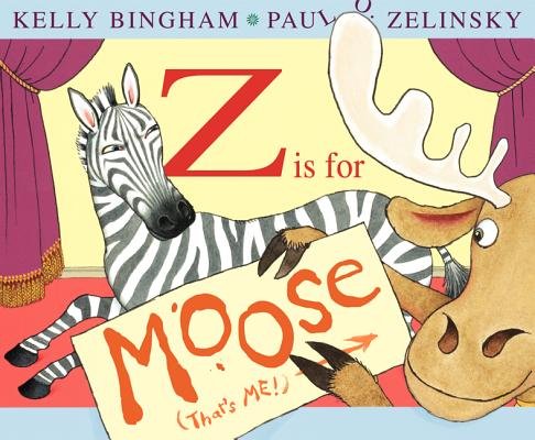 Z is for Moose by Kelly Bingham and illustrated by Paul O. Zelinsky, a children's book cover depicting an open stage with purple curtains and a red carpet. In the center is a zebra who is looking back at a moose holding a sign with the title of the book. The zebra is looking back with an annoyed expression. The background of the stage is a light yellow.