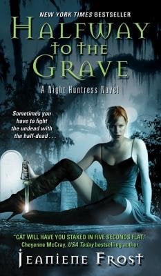 Halfway to the Grave by Jeanette Frost, a Night Huntress Novel book cover featuring a red-haired woman in dark clothing reclining against a misty cemetery backdrop with tombstones and Spanish moss-draped trees. The New York Times bestseller includes the tagline "Sometimes you have to fight the undead with the half-dead" and praise quotes from Charlaine Harris and other authors.