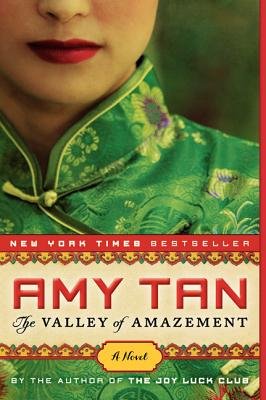 The Valley of Amazement by Amy Tan book cover featuring a zoomed in shot of a Chinese woman in traditional green clothing with golden and purple flowers.