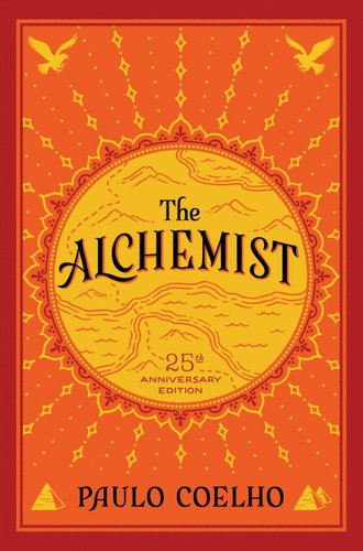 The Alchemist by Paulo Coelho book cover. On an orange cover, a yellow and red mandala contains parts of a map as well as the title.