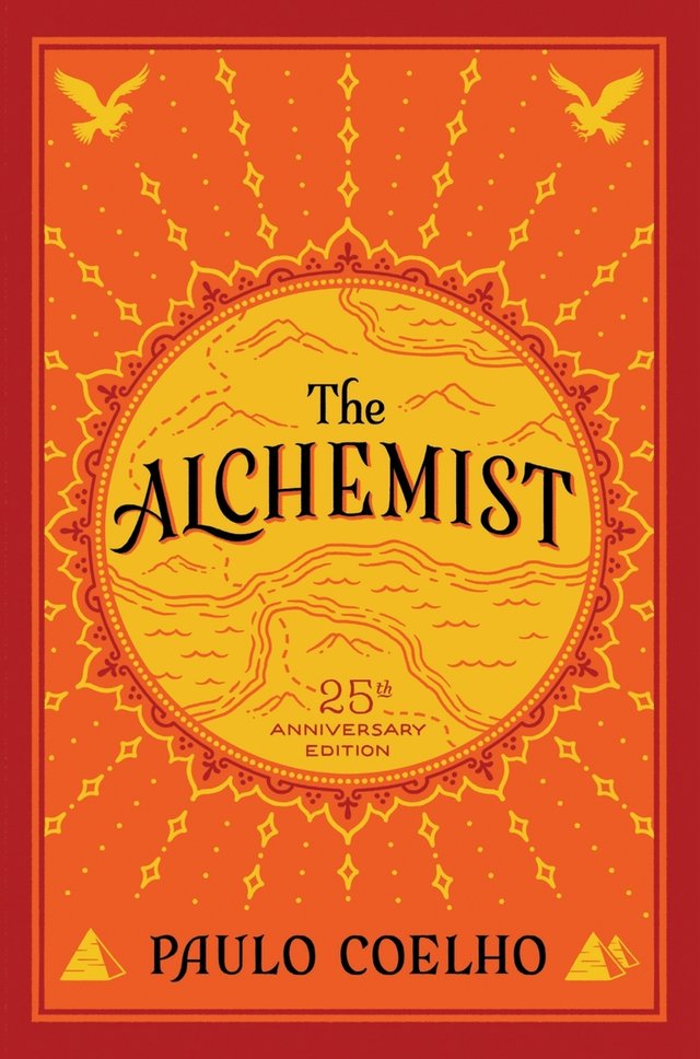 The Alchemist by Paulo Coelho, historical fiction novel cover depicting golden and orange color scheme with an intricate sun and desert.