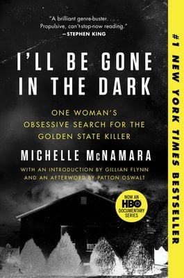 The cover of I'll Be Gone in the Dark, a true crime book, depicts a black and white photo of barn with a yellow stripe on the right side.