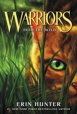 Warriors by Erin Hunter book cover. An orange cat with piercing green eyes stares off into the distance while crouched down on grass.