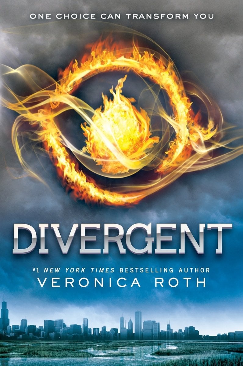 Cover of Divergent by Veronica Roth. There is a skyline in the bottom, with blue skies above it. Above the blue is smoke and there is a flame in a circle, all on fire.