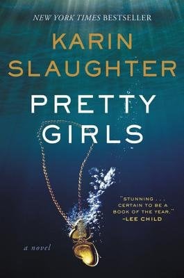 The book cover of 'Pretty Girls' by Karin Slaughter. Behind the yellow and white text is an image depicting a gold locket sinking through blue water.