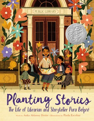 Book cover of Planting Stories: The Life of Librarian and Storyteller Pura Belpré by Anika Aldamuy Denise, Illustrated by Paola Escobar, featuring a brown-skinned woman with dark, curly hair sitting on a stoop and reading a book to a grown of brown-skinned children; flowers bloom from the pages of the open book.