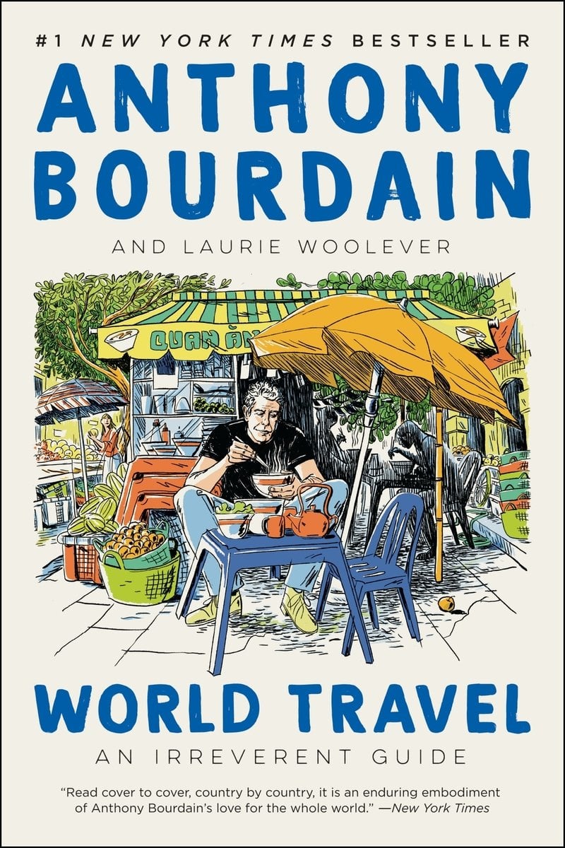 World Travel: An Irreverant Guide by Anthony Bourdain, a travel book cover depicting a colorful drawing of man eating in front of a restaurant. The author name and the title are both in a dark blue on a beige background.