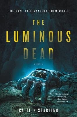A caver's hand gripping a piece of rock. Behind the hand is a glowing cavern. The title is in yellow.