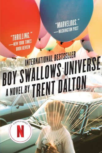 Boy Swallows Universe by Trent Dalton, book cover. There is a boy holding a few balloons and he is standing in front of cars.