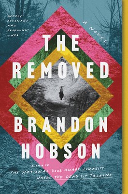 The Removed by Brandon Hobson book cover shows the background as a deep, forested landscape, at the center, a figure stands alone on a winding path. This image is framed by a series of colorful geometric shapes — reds, yellows, and greens —that draw inspiration from traditional American Indian art.