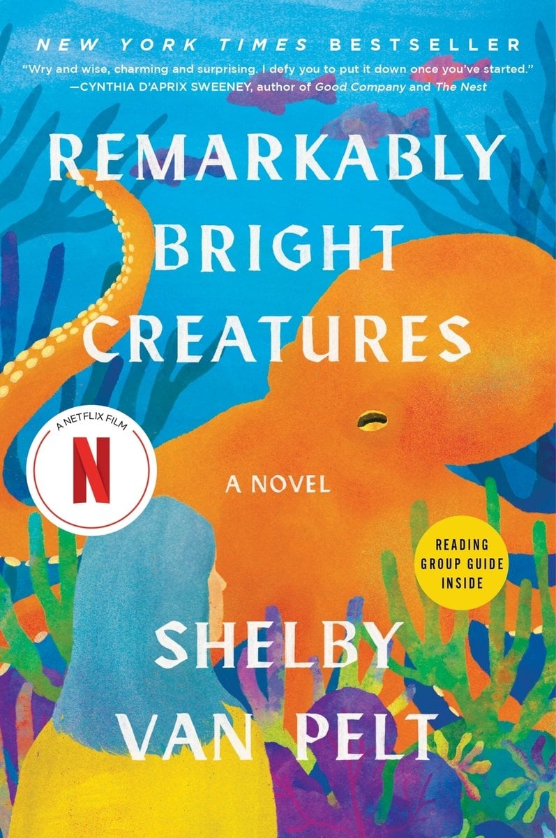 Remarkably Bright Creatures by Shelby Van Pelt featuring a picture of an orange octopus with seaweed and plants surrounding it as well as a lady looking in towards the octopus.