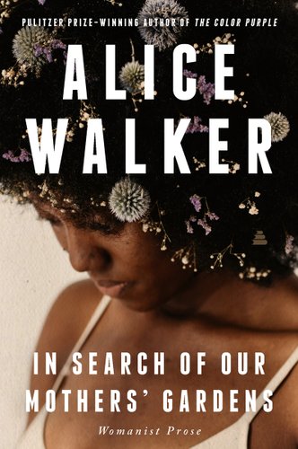 In Search of Our Mothers' Gardens by Alice Walker book cover. An up-close image of a young black woman in a white tank top with dandelions and similar flowers in her afro.