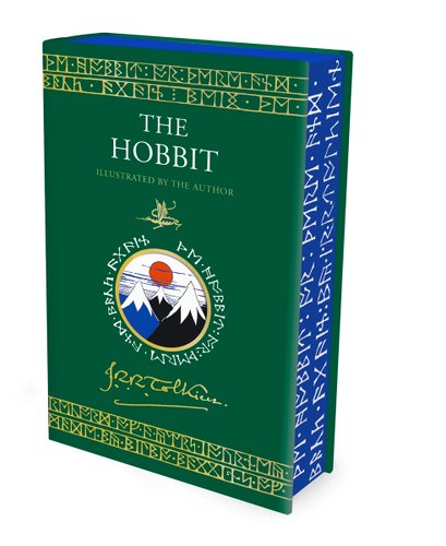 Book cover of "The Hobbit Illustrated" by J.R.R. Tolkien, featuring a green cover with a small illustration of three mountains under an orange sun surrounded by runic text in gold. Gold runic text borders the top and bottom edges of the cover, as well as the blue paperedges.