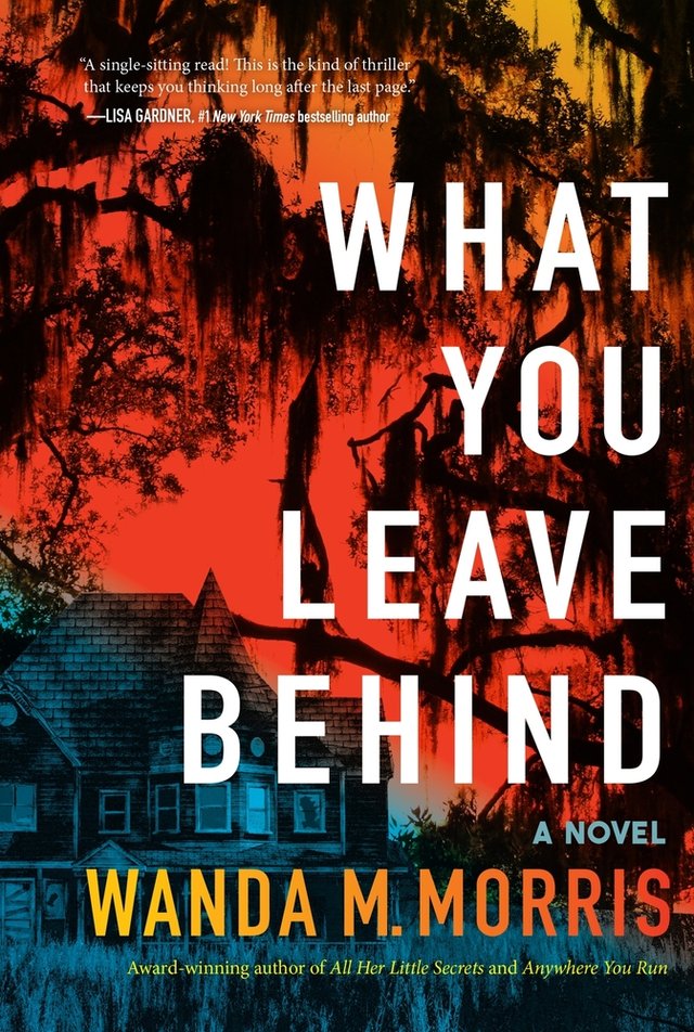 The book cover of What You Leave Behind: A Novel by Wanda M. Morris featuring a house and creeping trees with long hanging branches, an orange colored sky, and the house and low level vegetation in blue.