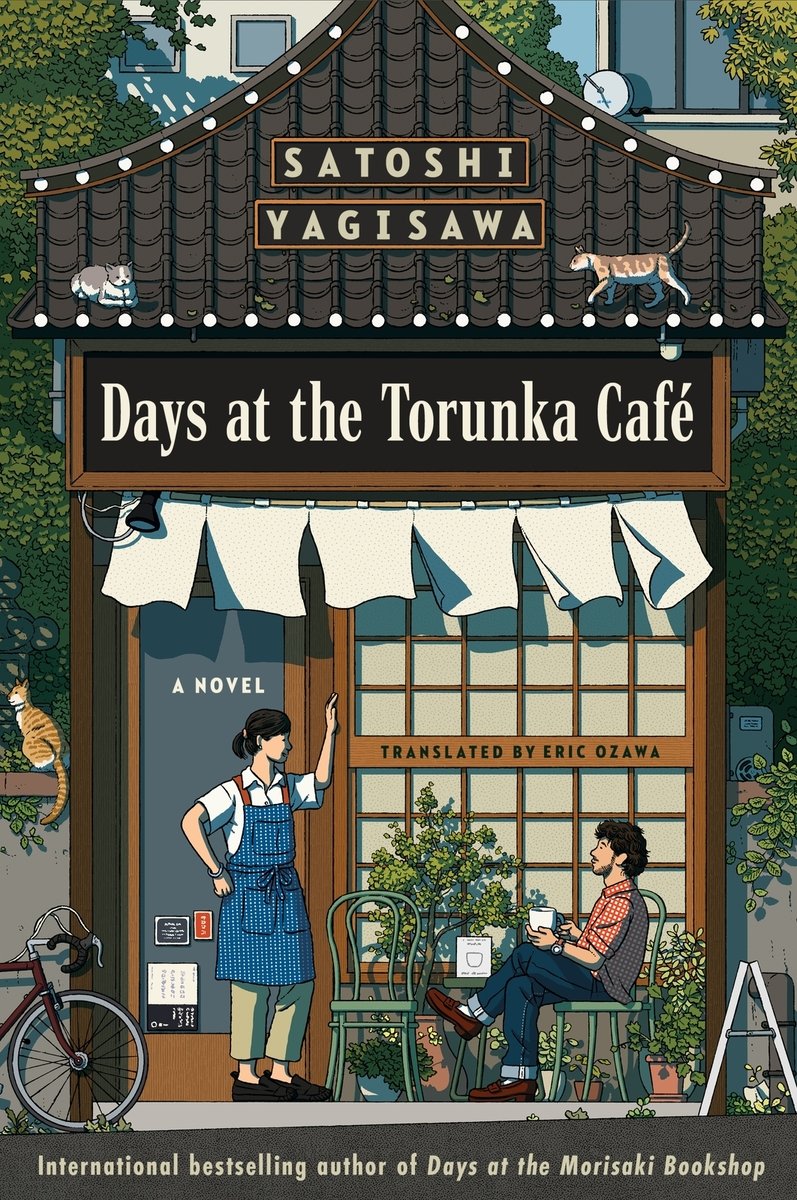 A cover of Days at the Trunka Café by Satoshi Yagisawa. There are two people and three cats standing outside of a cartoonish café.
