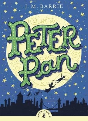The book cover for Peter Pan by J. M. Barrie. A blue starry sky featuring a pale yellow moon with the title in green. Below is the black silhouette of a city skyline with four young children flying through the sky.