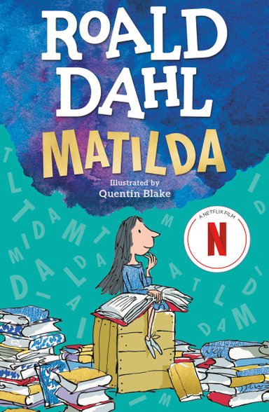 A small girl sits on a wooden crate, reading a large book. Countless books are scattered around her. Roald Dahl 'Matilda' rises above the girl encapsulated in a blue plume of smoke. Letters that spell the word Matilda fly in the background.