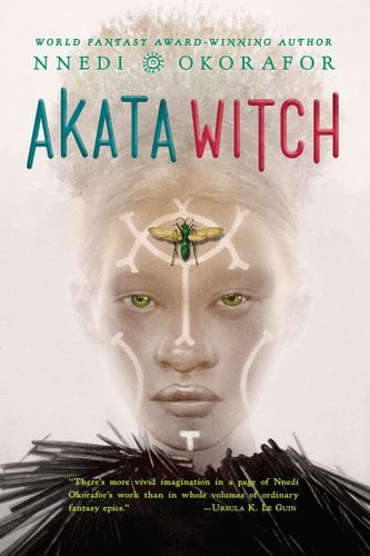 Akata Witch by Nnedi Okorafor book cover featuring a girl with lines on her face and a bug sititng in the middle of her forehead. Foggy white sky behind her head.