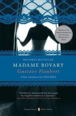 The cover of Madame Bovary by Gustave Flaubert. There is a black and white photograph of a woman in a fancy dress gazing out a window. There is a blue lace design bordering the top.