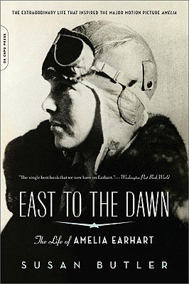 Side profile photo of Earhart with goggles and hat on her head.