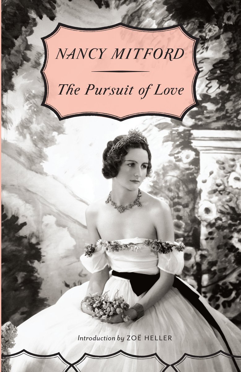The book cover for The Pursuit of Love by Nancy Mitford. In black and white, a woman in a white off-the-shoulder gown with a black sash holds flowers in her hands and looks off to the side. Behind her is a painted backdrop of flowers and columns.