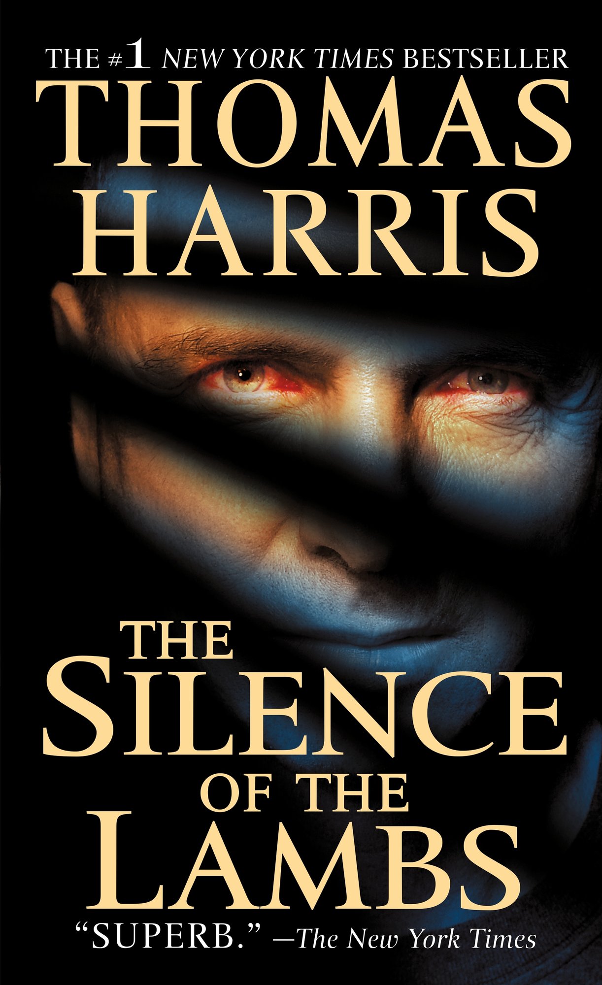 The cover of Thomas Harris' The Silence of the Lambs, with a man's face staring out at the viewer, crossed by horizontal shadows.