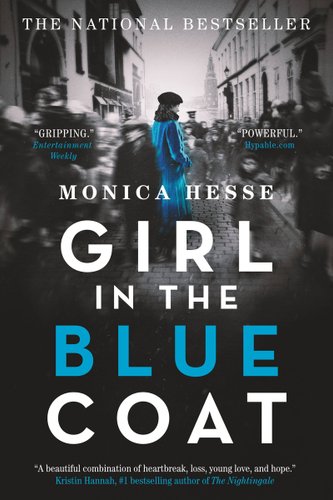 A woman wearing a blue dress and a black hat stands in the middle of the street. People walk around here in a blur.