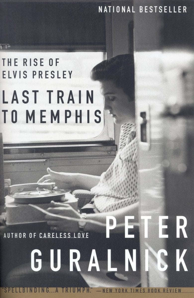 The Last Train to Memphis, a biography by Peter Guralnick. The cover is a black and white photo of Elvis Presley sitting in front of a record player.