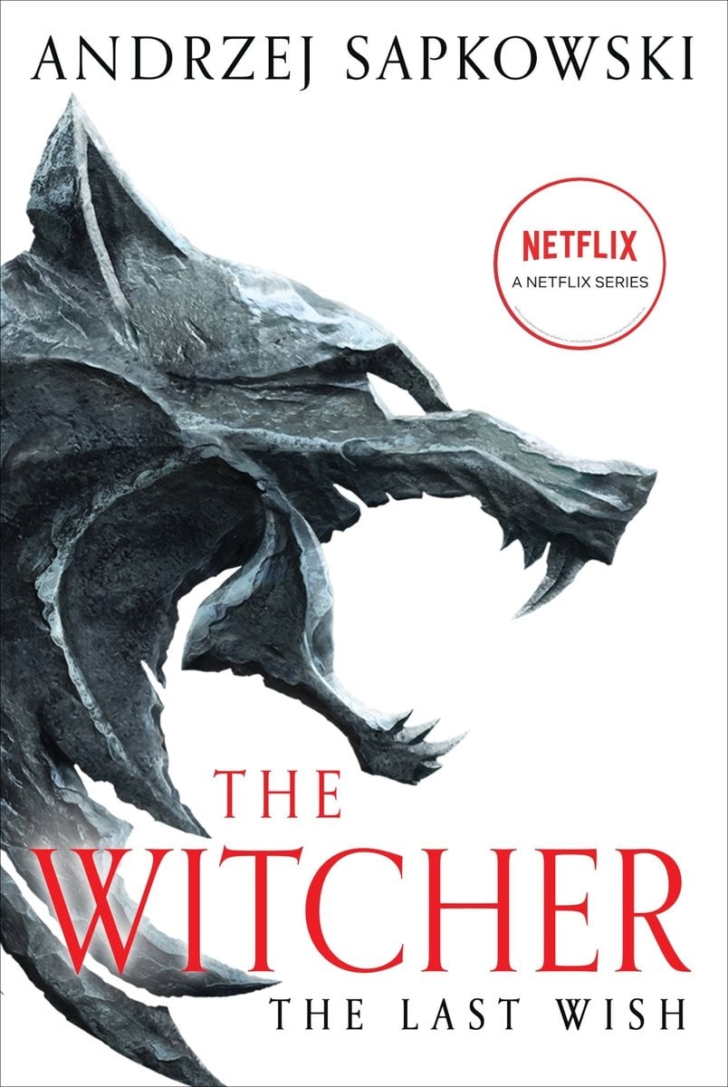 Cover of The Witcher The Last Wish by Andrzej Sapkowski. There is a white background, with a stone wolf head, with an open mouth, is coming out of the left side.