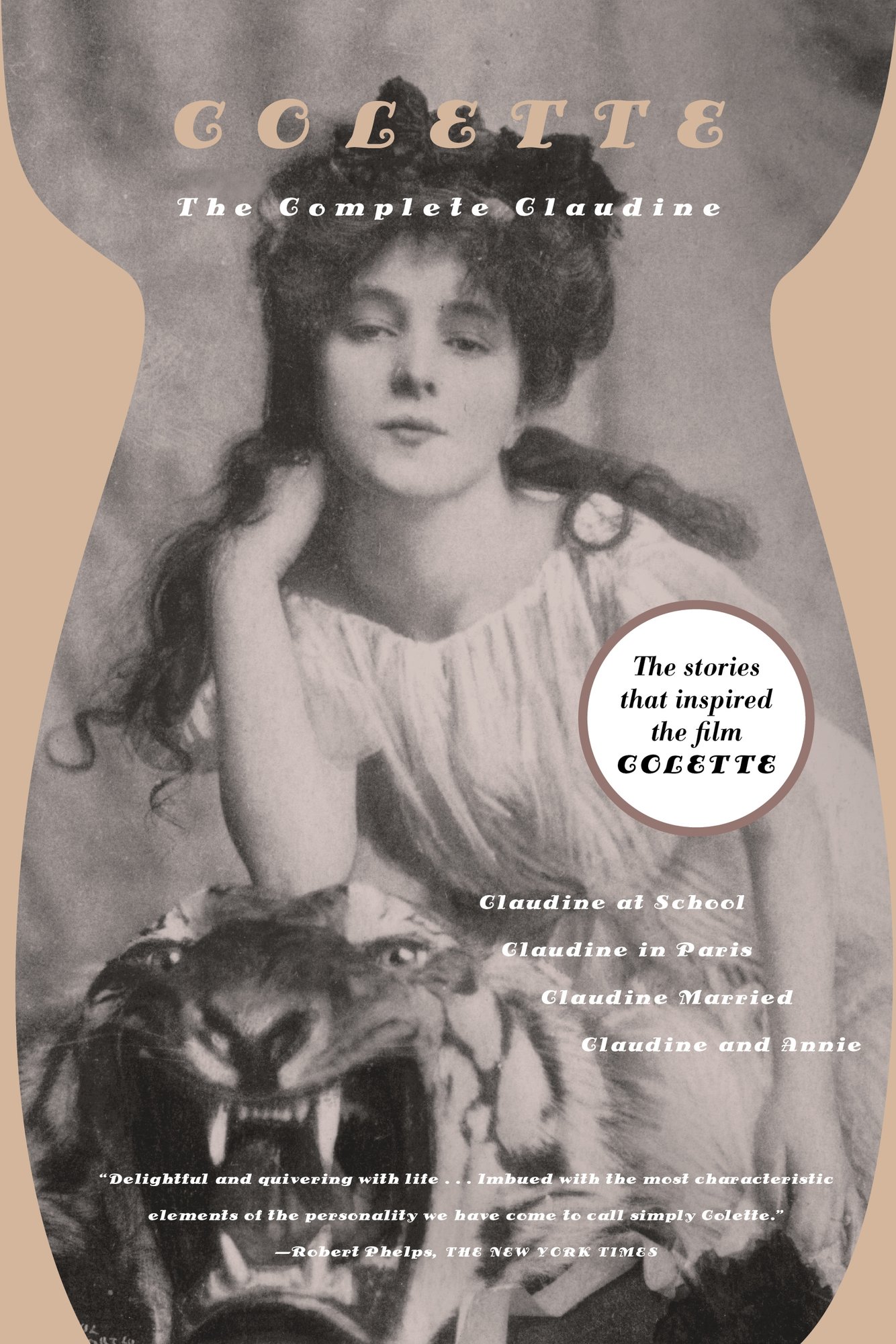 The book cover for The Complete Claudine by Colette. A black and white photograph of a young woman with dark curly hair wearing a white gown and resting her elbow on top of a taxidermy tiger.