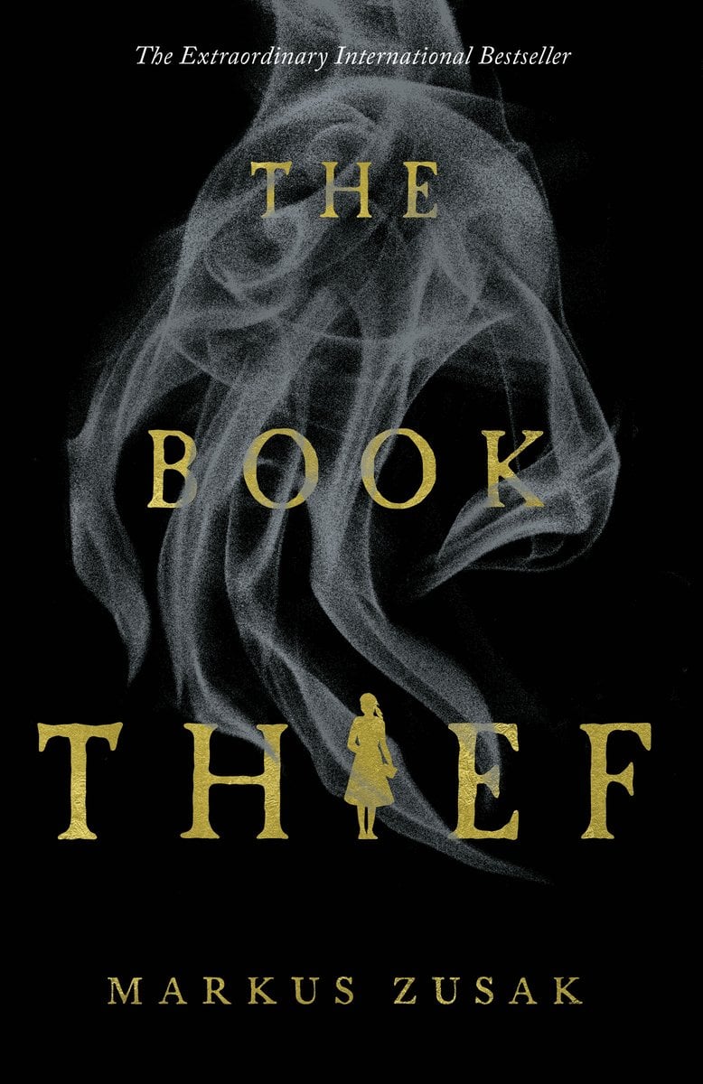 The Book Thief by Markus Zusak, a historical fiction novel. The cover has black and yellow/gold tones, with a picture of a hand about to push over a line of dominos.