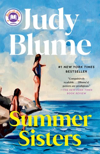 Two girls are on the edge of a sea. One stands and points out. The other is sitting and looking up at the other girl.