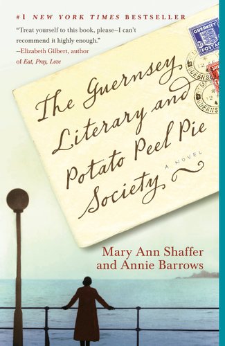 The cover of The Guernsey Literary and Potato Peel Pie Society by Mary Ann Shaffer and Annie Barrows. There is a photograph of a woman leaning forward on a railing next to a lamppost. She is overlooking a vast ocean. The title is written in cursive script on a postcard with old stamps.