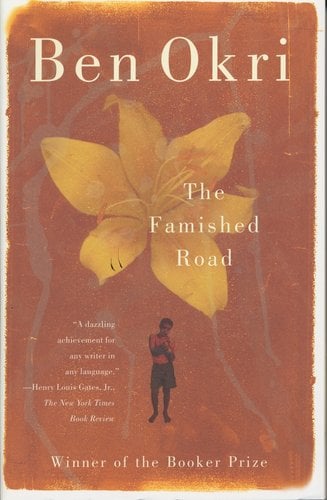 The Famished Road by Ben Okri, book cover depicting a big yellow flower taking up most of the cover with a little boy much smaller underneath in front of a brown background.