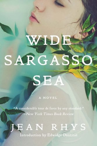 Face of a woman in milky water surrounded by green plants. On top in white letters is the title "Wide Sargasso Sea" and the name of the author "Jean Rhys"