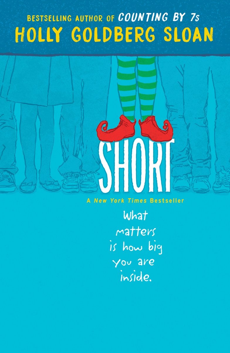Short by Holly Goldberg Sloan, a fictional blue book cover depicting legs standing in a straight line and on pair of legs, shorter than the rest, with green and blue striped stockings and red shoes, standing on the word "short."