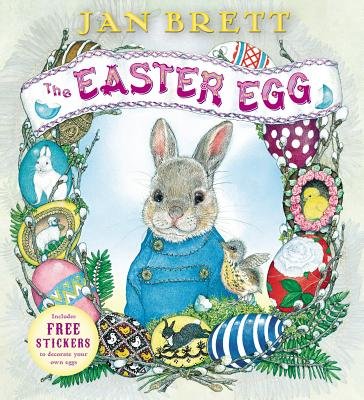 The Easter Egg by Jan Brett, book cover. The decorative edges of vines, birds, and eggs surround a portrait of a bunny in a blue coat. A sign on top of his image displays the title.