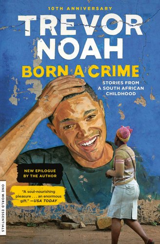 An image of a blue mural on a wall. In the center of the mural is a painting of Trevor Noah laughing with his hand on his head. There is a black woman walking by the mural and looking at it. It says Trevor Noah at the top in white and Born A Crime below it in yellow.
