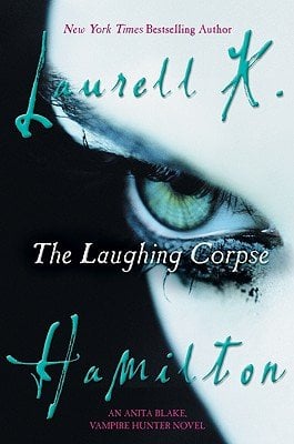 The Laughing Corpse by Laurell K. Hamilton. A book cover featuring half of a girl's face with a green eye, smudged eyeliner, and black hair.