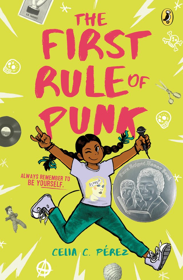 The First Rule of Punk by Celia C. Pérez shows Malú doing a rockstar jump with a microphone in her right hand and the rock symbol on her right. The background is green with lightning bolts and items like a vinyl and scissors floating around.