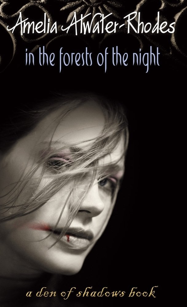 In The Forests of the Night by Amelia Atwater-Rhodes, the black book cover depicts a woman's face with a smear of blood on her mouth.