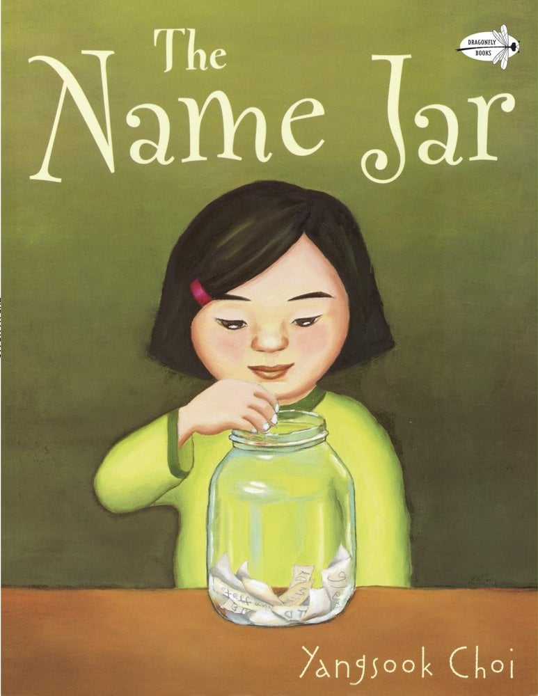 The Name Jar by Yangsook Choi, a children's picture book cover depicting a girl in a light green shirt reaching into a jar filled with paper slips on a dark green background.