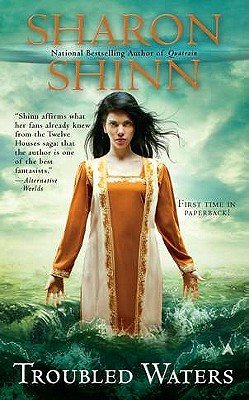 Troubled Waters by Sharon Shinn, a fantasy book cover depicting a dark-haired woman wearing an orange and white dress emerging from the ocean, with crashing waves. The title is printed in a thin orange font.