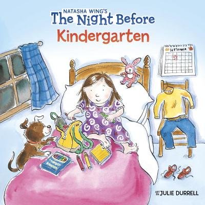 A girl is laying on her bed getting ready for school in the morning. She is packing her backpack with crayons and notebooks. Her outfit for the day is laid out on the chair next to her, a yellow shirt, blue jeans, and red shoes. All while her dog looks up at her with his paws on the bed.