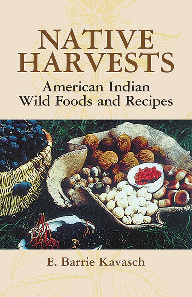 Native Harvests: American Indian Wild Foods and Recipes by E. Barrie Kavasch book cover of an image of foraged ingredients like acorns, walnuts, and berries. The brown capitalized title text is at the top of the cover placed over a line work illustration of a flower.