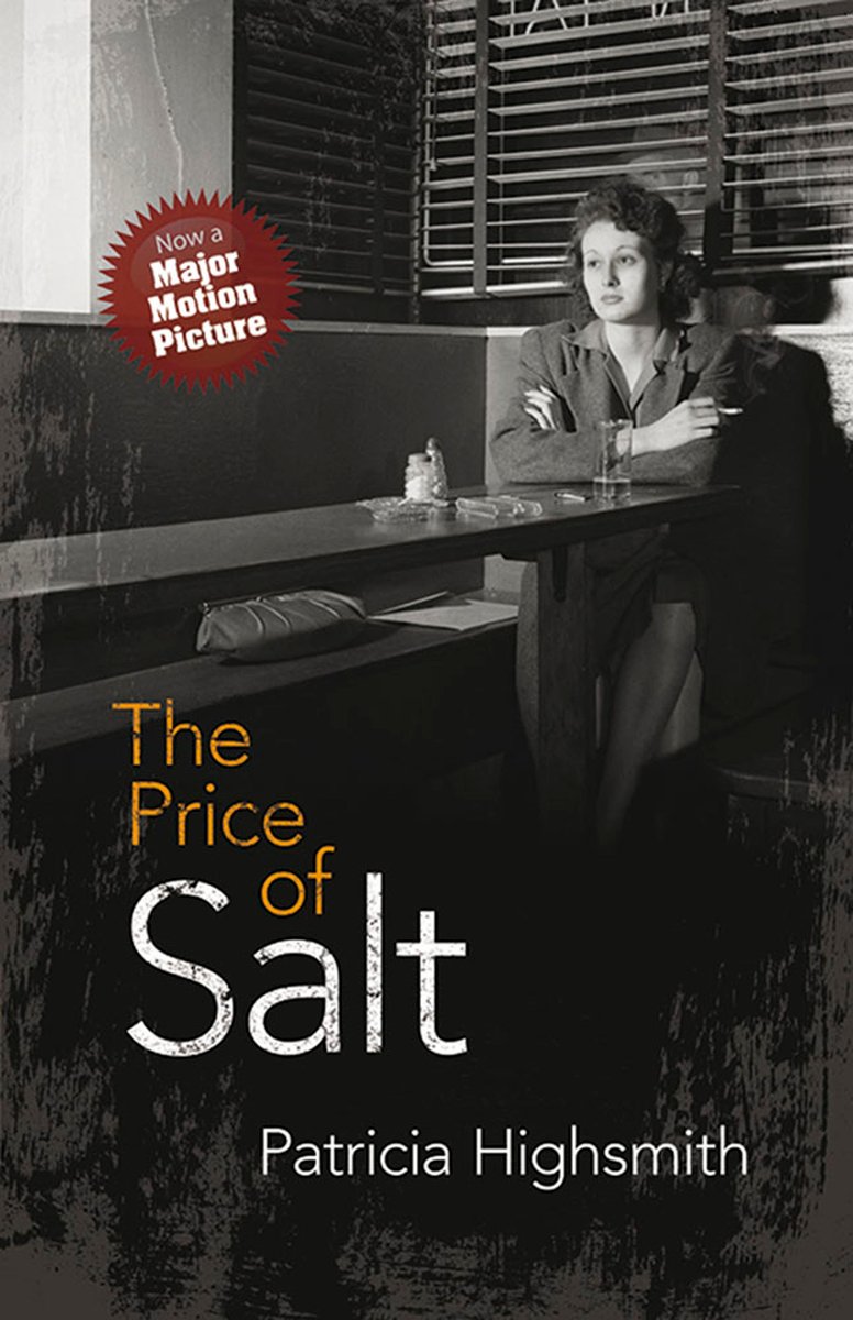 A Woman sits at a diner table smoking a cigarette.