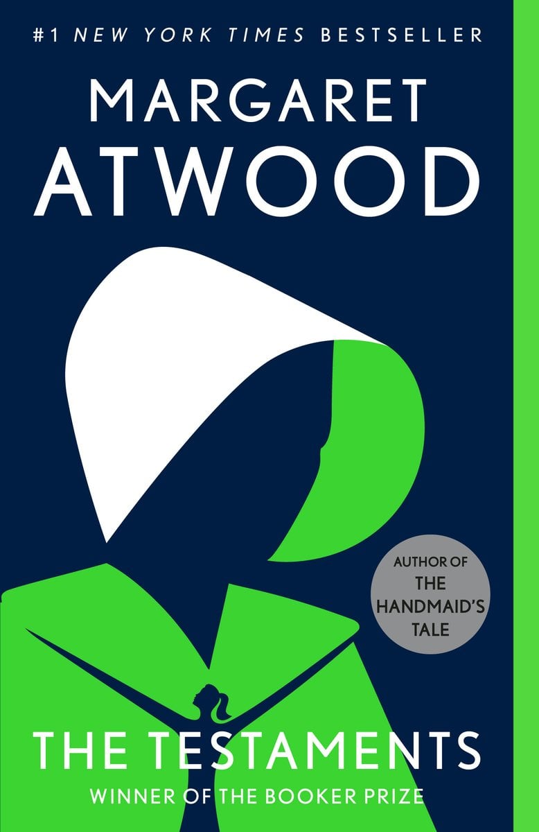The Testaments by Margaret Atwood speculative fiction book cover depicts the profile of a women's face in a green outfit and white head covering on a navy blue background.