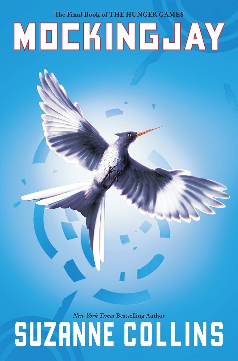 Book cover of Mockingjay by Suzanne Collins. On a light blue background, a gray and white bird has its wings outstretched to fly and is haloed by a white light. The title is in white and outlined in red and the author's name is in white.