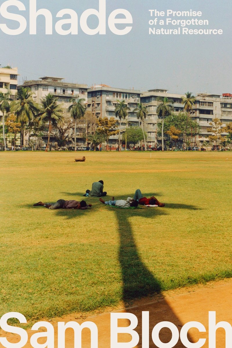 Shade by Sam Bloch nonfiction book cover depicting a sunny day in a city with palm trees. In the background, houses are lining the street and there is a grassy field in front of them. In the grassy field, the shade of a lone palm tree stretches across with four people laying in its shade.